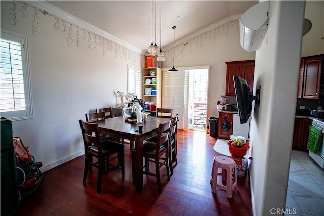 dining area with crown molding, a wall mounted AC, a healthy amount of sunlight, and wood finished floors