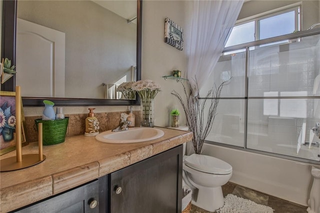 full bathroom with toilet, bath / shower combo with glass door, and vanity