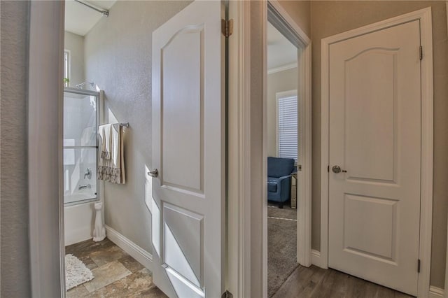 bathroom with crown molding and hardwood / wood-style flooring