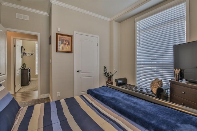 bedroom with crown molding and carpet flooring