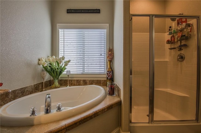 bathroom featuring separate shower and tub