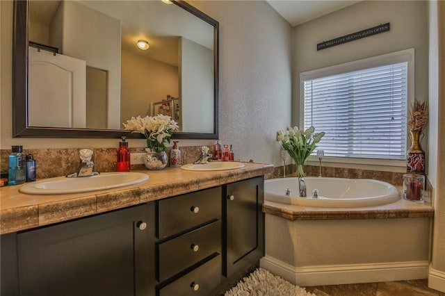 bathroom with a relaxing tiled tub and vanity