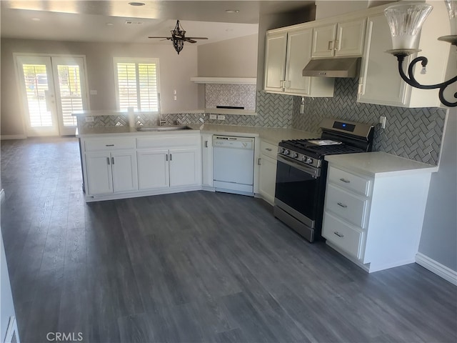 kitchen featuring dark hardwood / wood-style floors, kitchen peninsula, white dishwasher, white cabinetry, and stainless steel gas stove