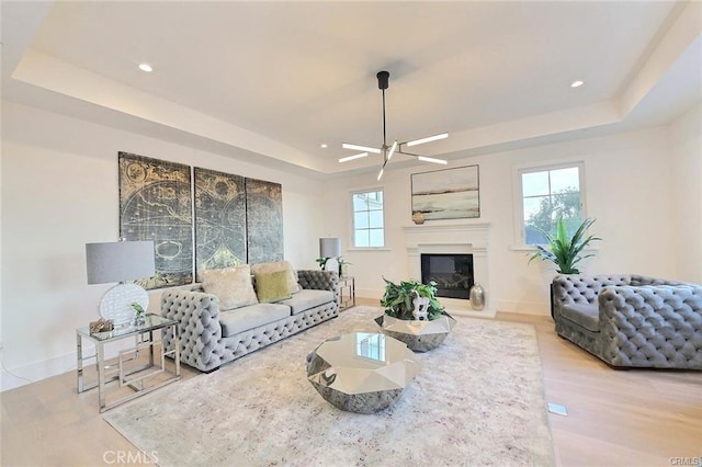 20487 Gartel Dr, Walnut, CA 91789 - living area featuring a tray ceiling, wood finished floors, baseboards, a glass covered fireplace, and recessed lighting
