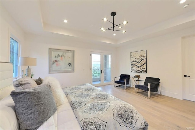20487 Gartel Dr, Walnut, CA 91789 - bedroom featuring light wood-style floors, access to exterior, a tray ceiling, a chandelier, and french doors