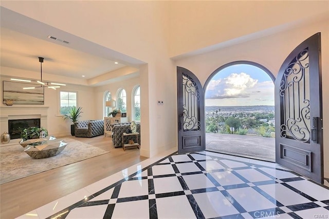 20487 Gartel Dr, Walnut, CA 91789 - foyer with ceiling fan, a fireplace with raised hearth, a raised ceiling, recessed lighting, and baseboards