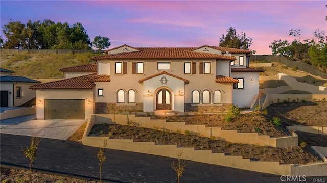 20487 Gartel Dr, Walnut, CA 91789 - mediterranean / spanish-style home featuring driveway, stucco siding, a tile roof, an attached garage, and stone siding