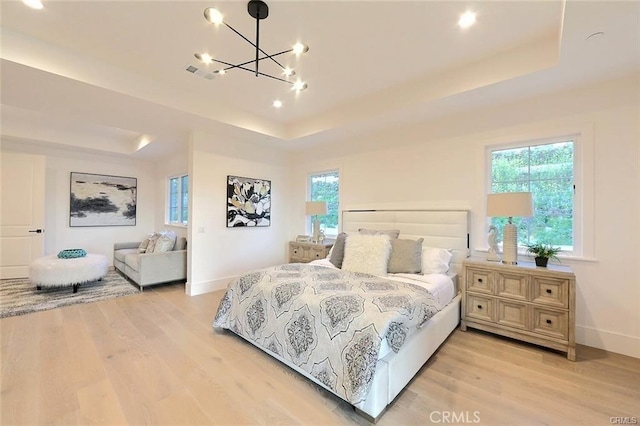 20487 Gartel Dr, Walnut, CA 91789 - bedroom featuring a tray ceiling, light wood-type flooring, a chandelier, and baseboards