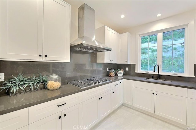 20487 Gartel Dr, Walnut, CA 91789 - kitchen featuring wall chimney range hood, a sink, stainless steel gas cooktop, dark countertops, and white cabinetry