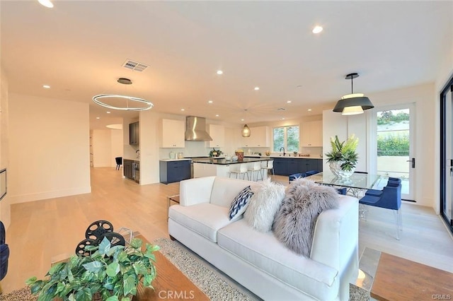 20487 Gartel Dr, Walnut, CA 91789 - living room featuring light wood-style floors, recessed lighting, and baseboards