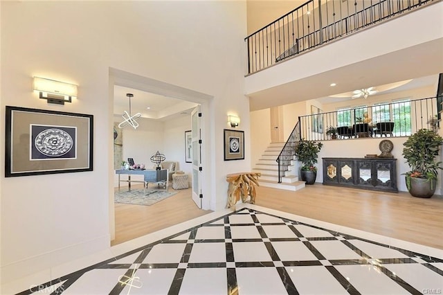 20487 Gartel Dr, Walnut, CA 91789 - foyer with stairs, inlaid floor details, wood finished floors, a high ceiling, and ceiling fan