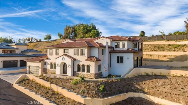 20487 Gartel Dr, Walnut, CA 91789 - mediterranean / spanish-style house featuring stucco siding, stone siding, a garage, driveway, and a tiled roof
