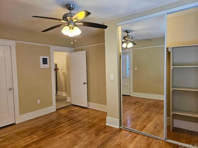 unfurnished bedroom with ceiling fan and wood-type flooring