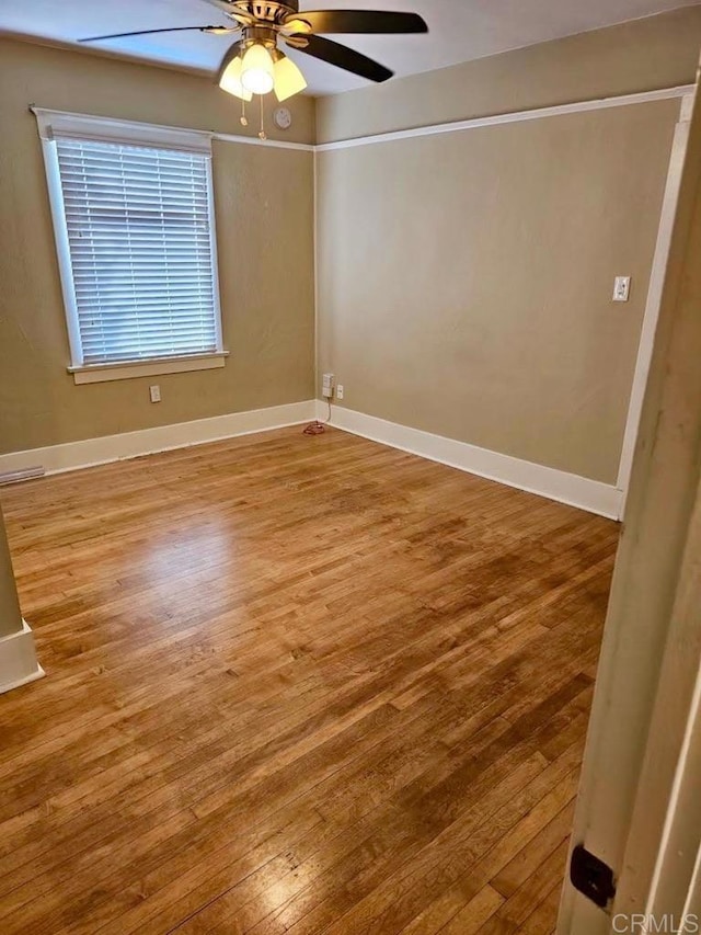 spare room with ceiling fan and wood-type flooring