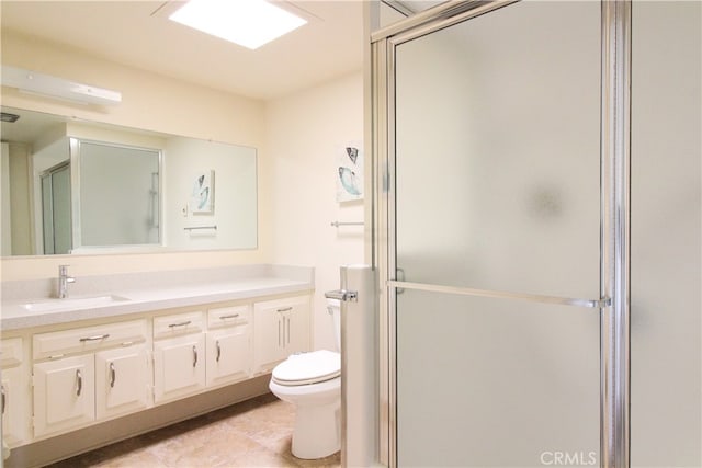 bathroom with vanity, tile patterned flooring, toilet, and a shower with shower door