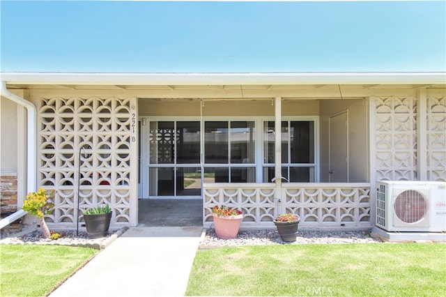 property entrance featuring ac unit and a yard