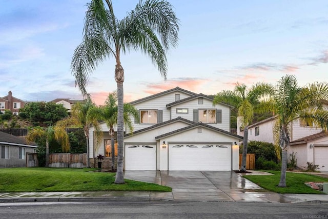 view of front facade with a garage and a yard