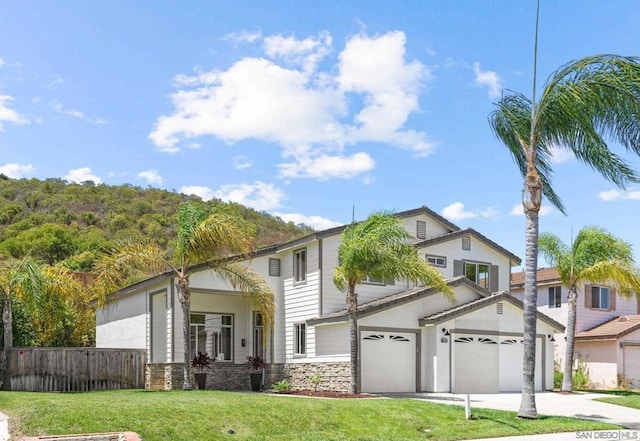 view of front of house with a garage and a front yard