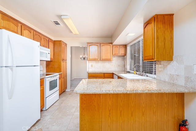 kitchen featuring backsplash, white appliances, kitchen peninsula, light tile patterned floors, and sink