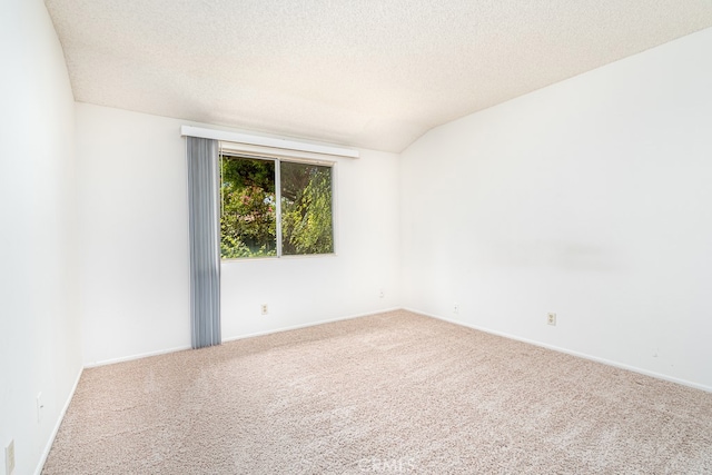 unfurnished room with carpet floors, a textured ceiling, and vaulted ceiling