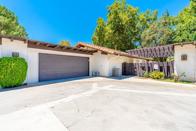 view of front of home featuring a garage and central air condition unit