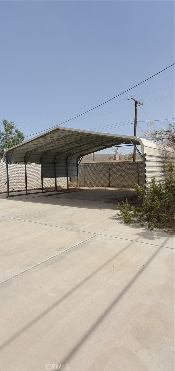 view of parking / parking lot featuring a carport