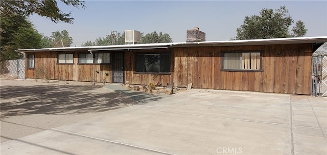 view of front of house featuring an outbuilding and central air condition unit