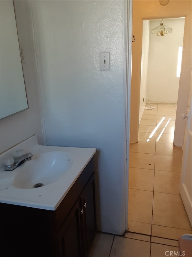 bathroom featuring vanity, tile patterned floors, and an inviting chandelier