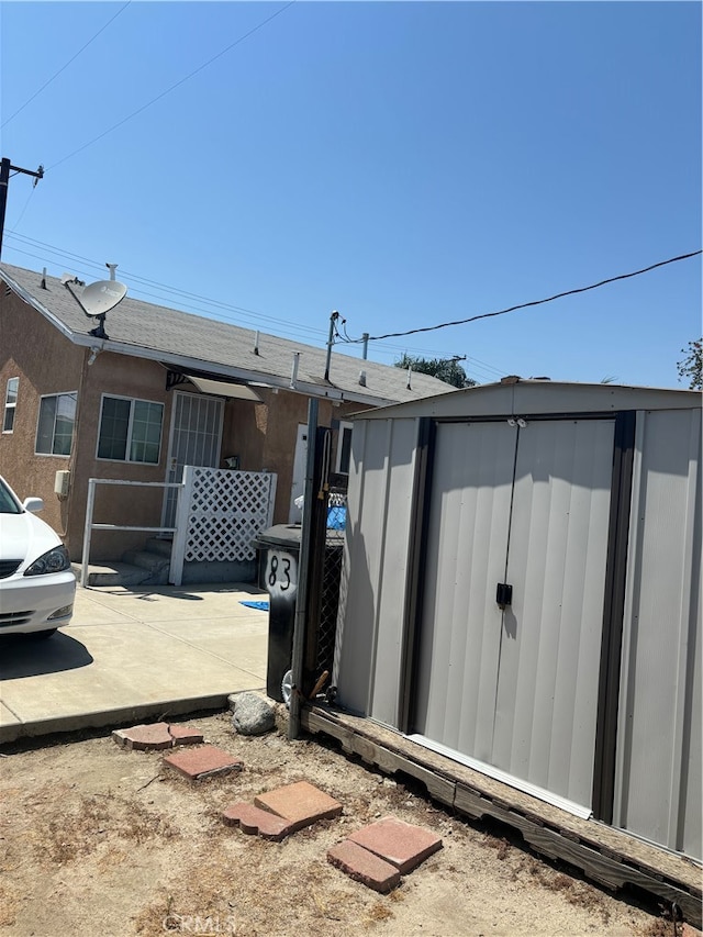 exterior space featuring a patio area and a storage unit