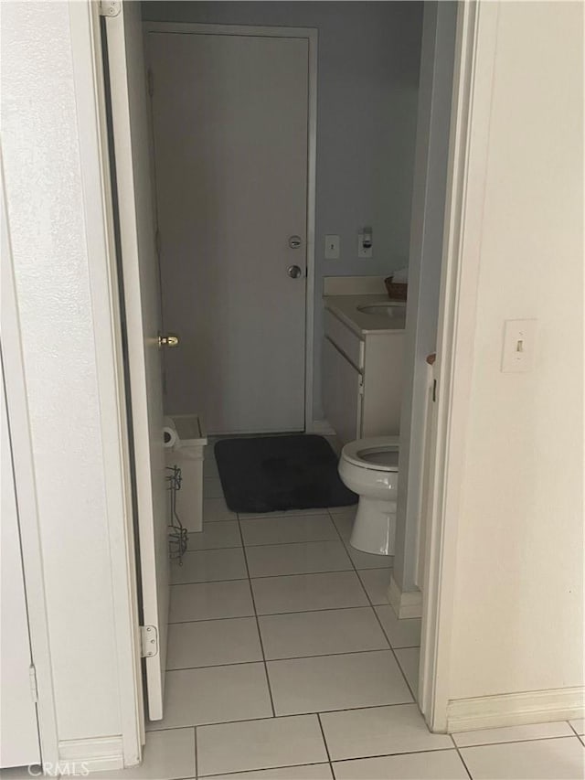 bathroom featuring toilet, tile patterned floors, and vanity