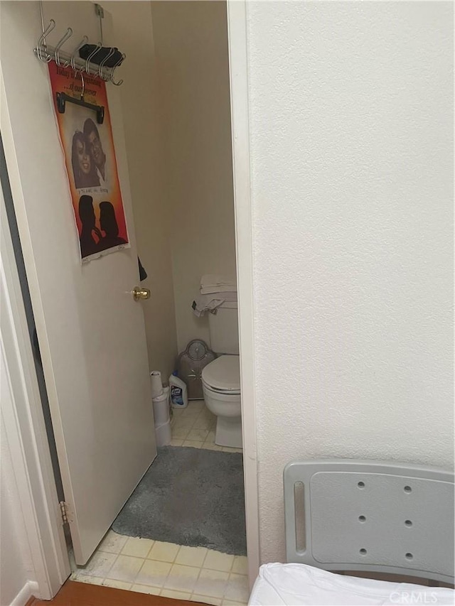 bathroom with toilet and tile patterned floors