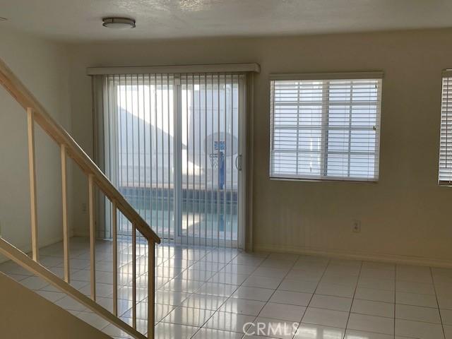 tiled spare room with a wealth of natural light