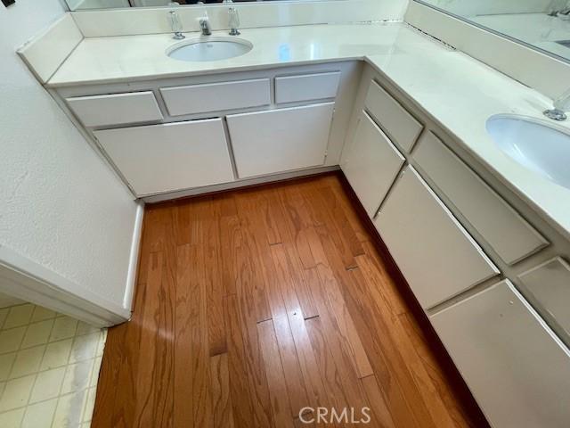 bathroom with hardwood / wood-style flooring and vanity