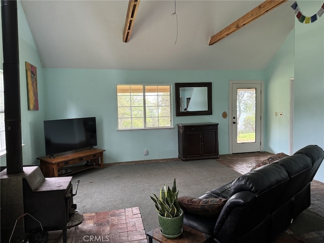 living room with carpet, vaulted ceiling with beams, and plenty of natural light