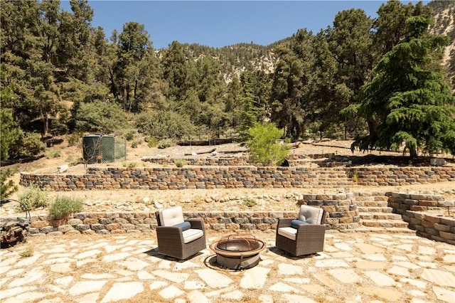 view of patio / terrace featuring an outdoor fire pit