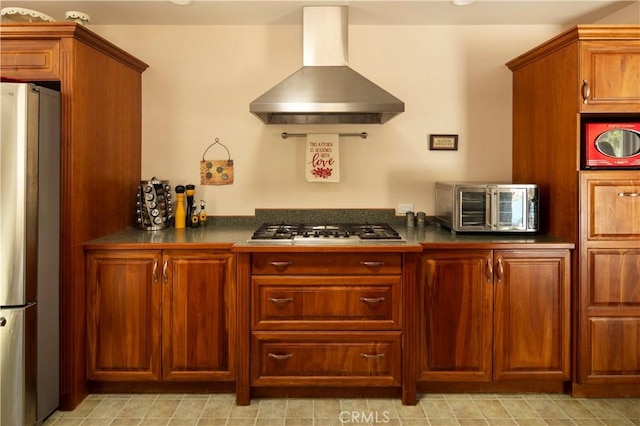 kitchen with ventilation hood and appliances with stainless steel finishes