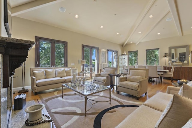 living room featuring beam ceiling, high vaulted ceiling, light hardwood / wood-style floors, and french doors