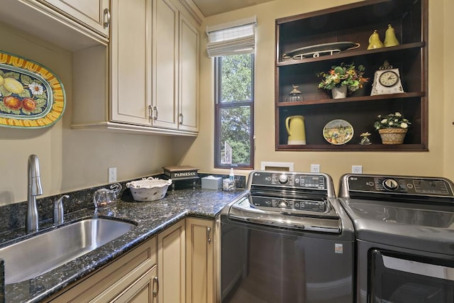 washroom featuring cabinets, sink, and washing machine and clothes dryer