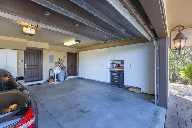 garage featuring a garage door opener and electric panel