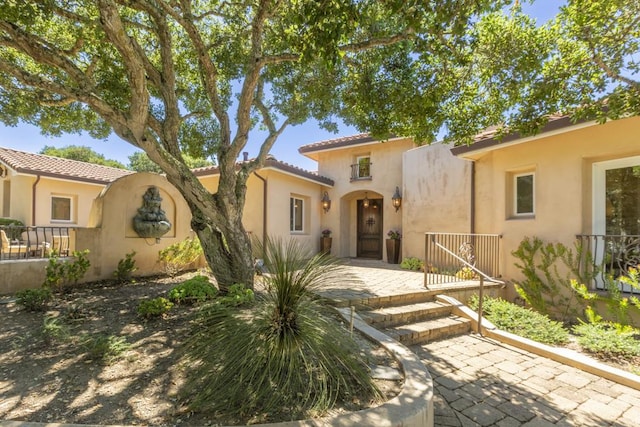 mediterranean / spanish-style home with a patio area