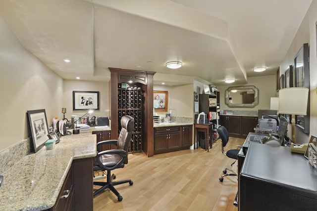 office area featuring built in desk and light hardwood / wood-style flooring