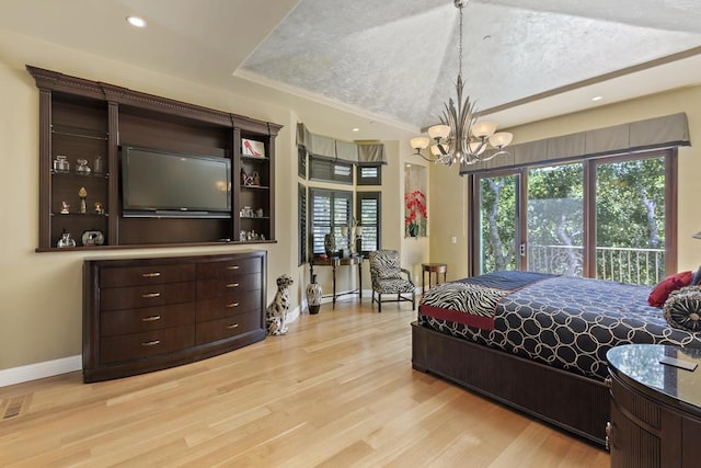 bedroom featuring an inviting chandelier, access to exterior, and light hardwood / wood-style floors