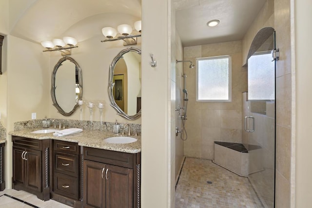 bathroom with vanity and a shower with shower door