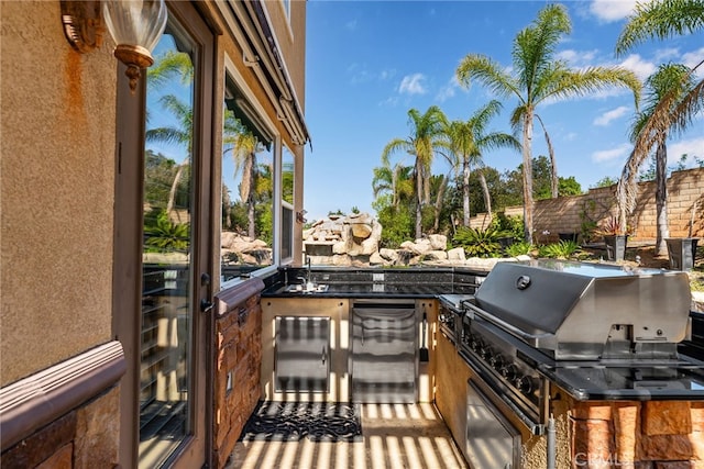 view of patio / terrace with area for grilling and an outdoor kitchen