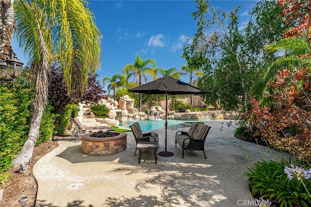 view of patio / terrace featuring an outdoor fire pit