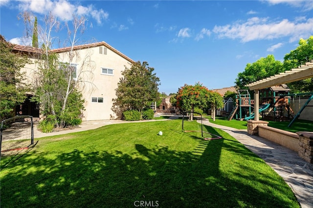 view of home's community featuring a yard and a playground