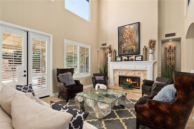 living room featuring a towering ceiling and a fireplace