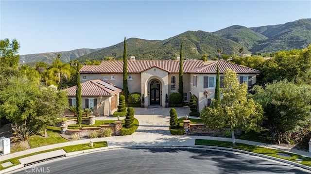 mediterranean / spanish-style home with a mountain view