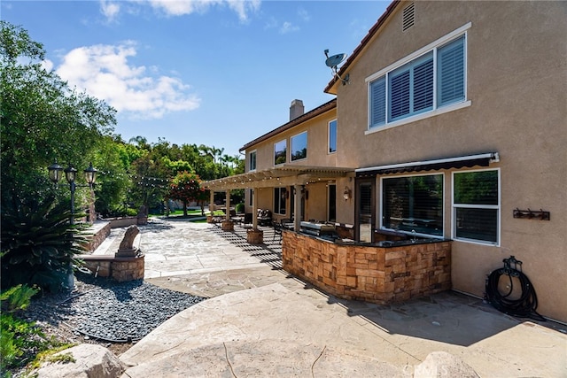 view of patio featuring a fire pit and a pergola