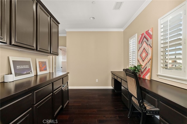 office area with built in desk, crown molding, and dark hardwood / wood-style flooring